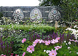 These stained glass windows are from the Katherine Parr garden, designed by Yvonne Mathews. As part of the Six Wives of Henry VIII show gardens at the 2009 Hampton Court Palace Flower Show. The three stained glass windows, include the crest of Katherine Parr, on the right, the virgin Mary in the middle and the crest of Henry VIII on the left